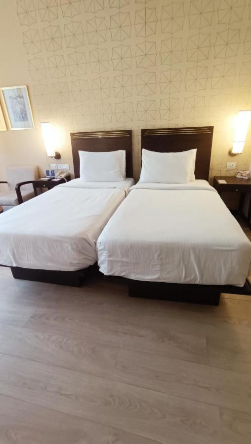 Marasa Sarovar Premiere Tirupati Exterior photo Two single beds